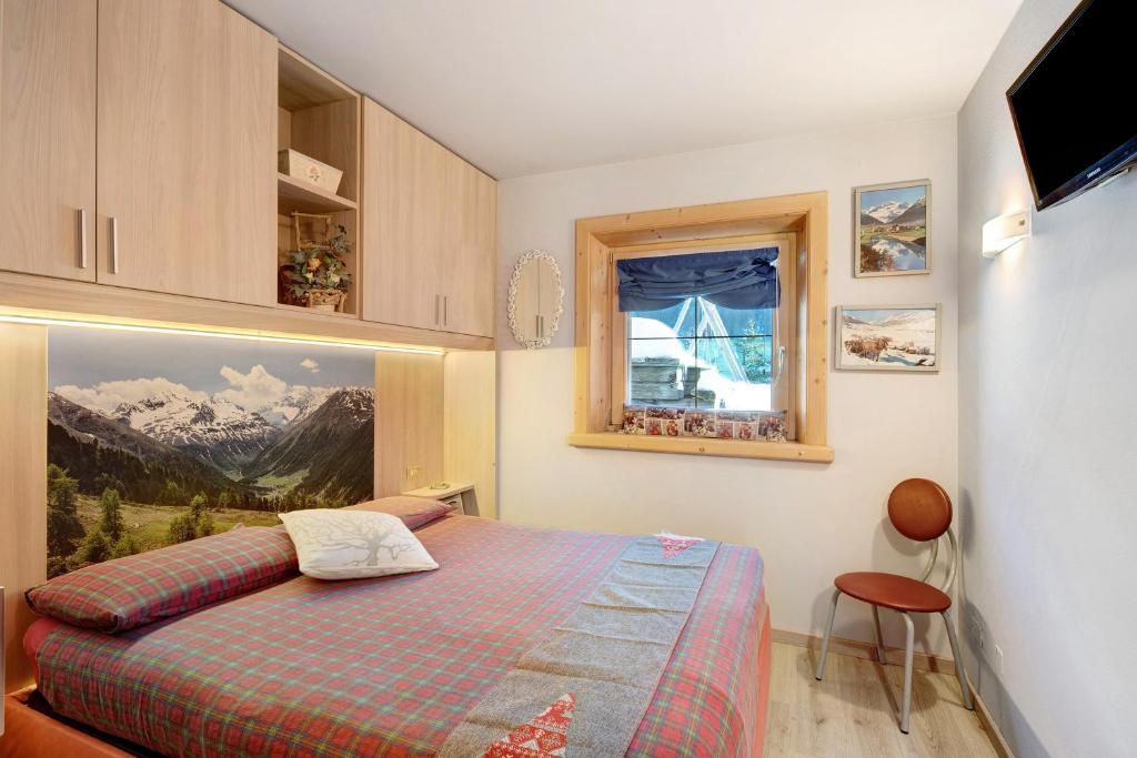A bed or beds in a room at Baita del Sole Appartamento 3