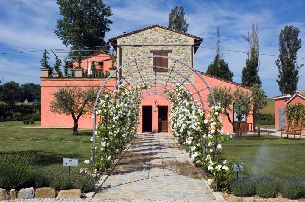 an archway with flowers in front of a building at Agriturismo Casale Le Selvette in Ripa