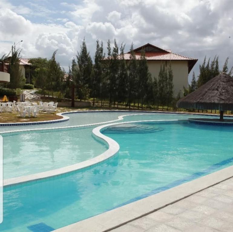 une grande piscine d'eau bleue dans l'établissement Flat no Hotel Fazenda Monte Castelo em Gravatá - PE, à Gravatá