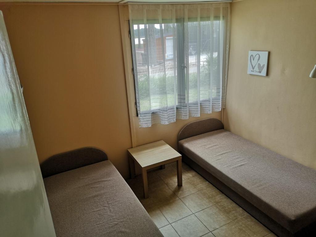 Posteľ alebo postele v izbe v ubytovaní Rózsa Vendégház Vadkerti tó