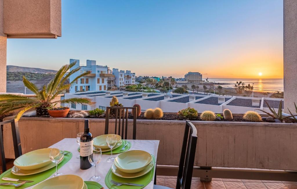 a dining table with a view of the ocean at MEDANO4YOU The Rosuca Holiday Home in El Médano