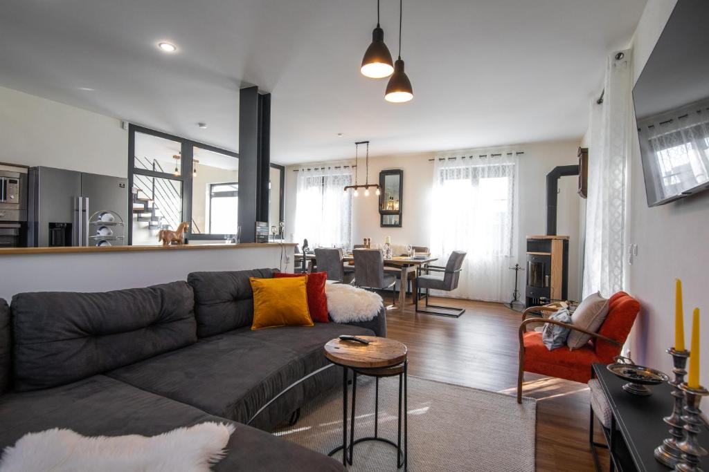 a living room with a couch and a dining room at Ferienhaus Donautal in Sigmaringen