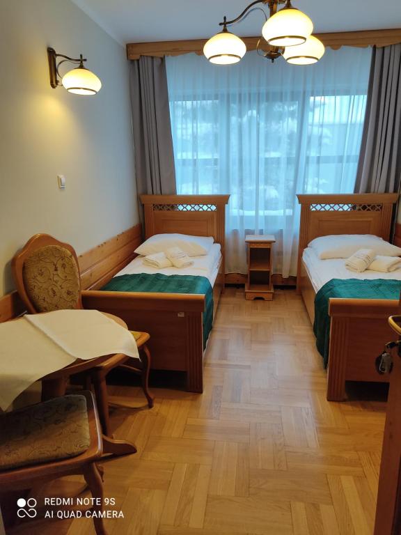 Posteľ alebo postele v izbe v ubytovaní Pokoje Gościnne Zakopane
