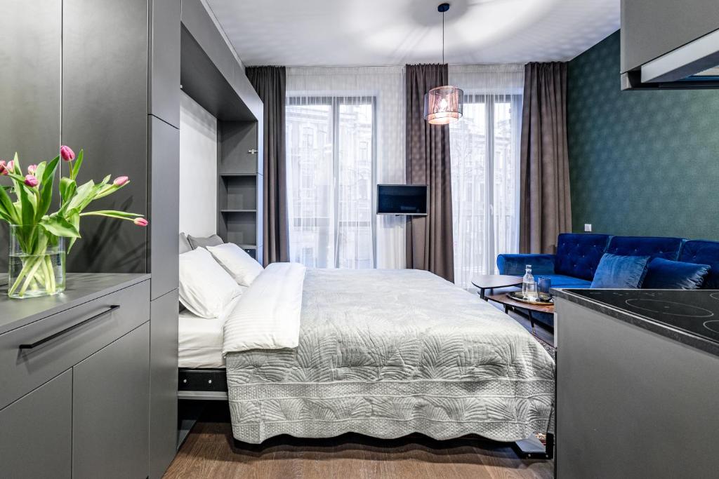 a hotel room with a bed and a kitchen at Vilnius Old-Town Renaissance Studios in Vilnius