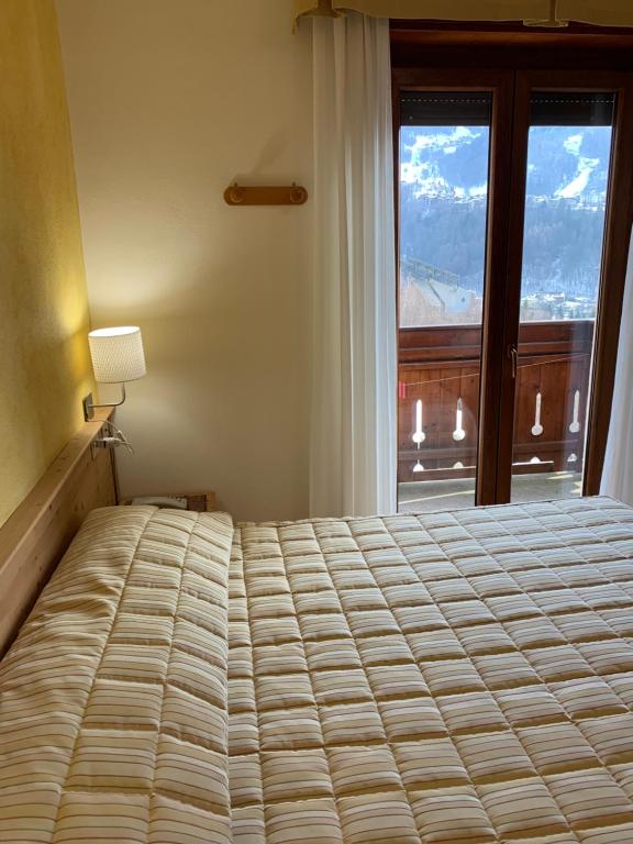 Postel nebo postele na pokoji v ubytování Hotel Genzianella