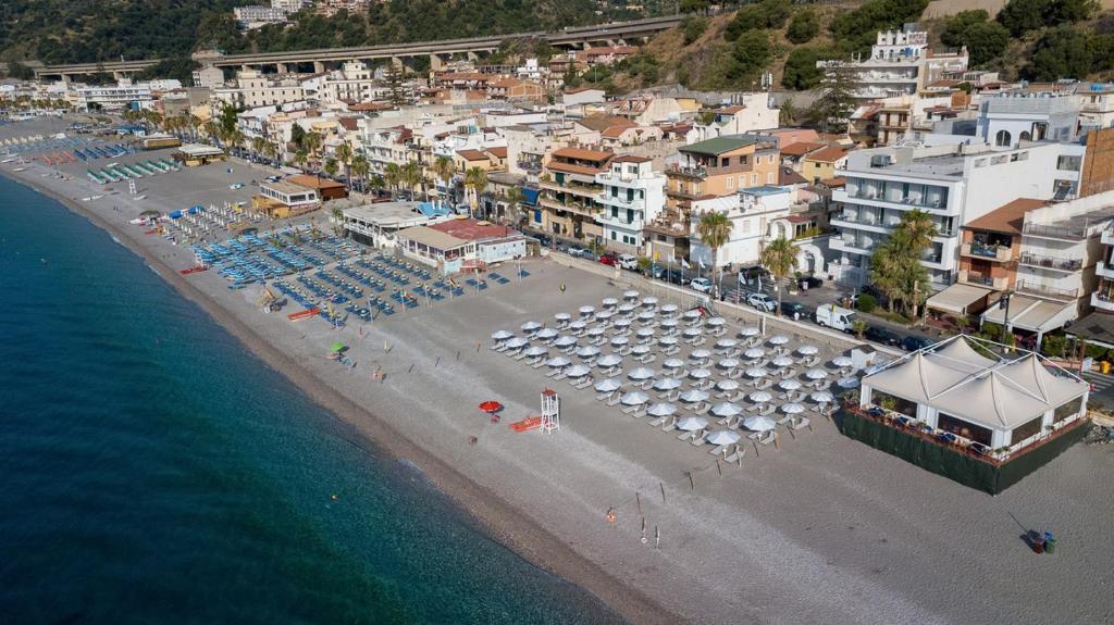 an aerial view of a beach with umbrellas and the ocean at Albatros Beach Hotel in Letojanni