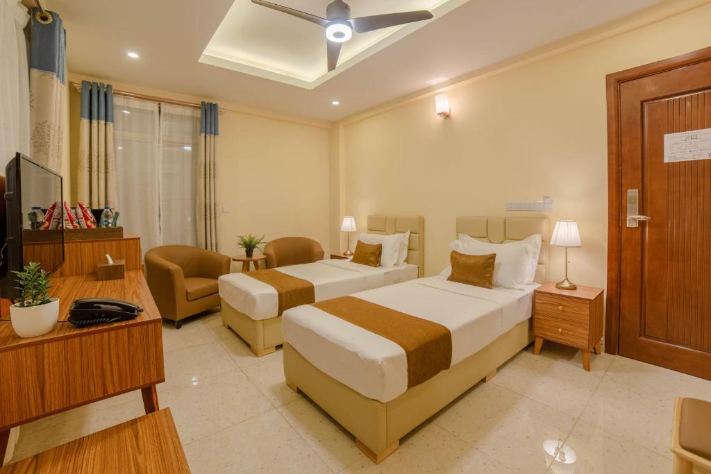 Postel nebo postele na pokoji v ubytování Amber Beach Hotel