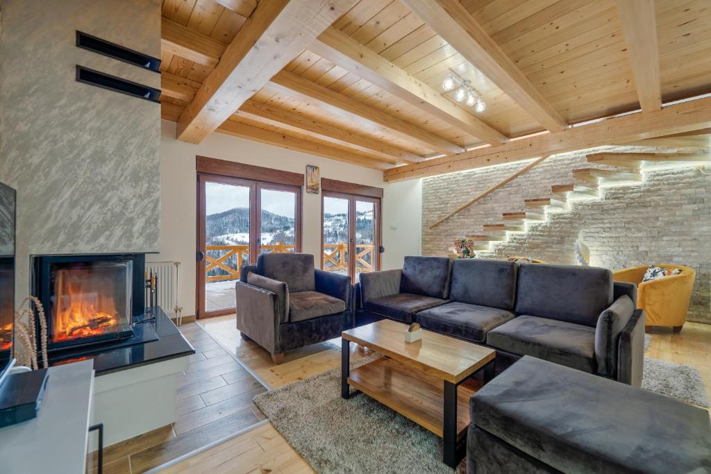 a living room with a couch and a fireplace at Idila Zaovinskog jezera in Zaovine