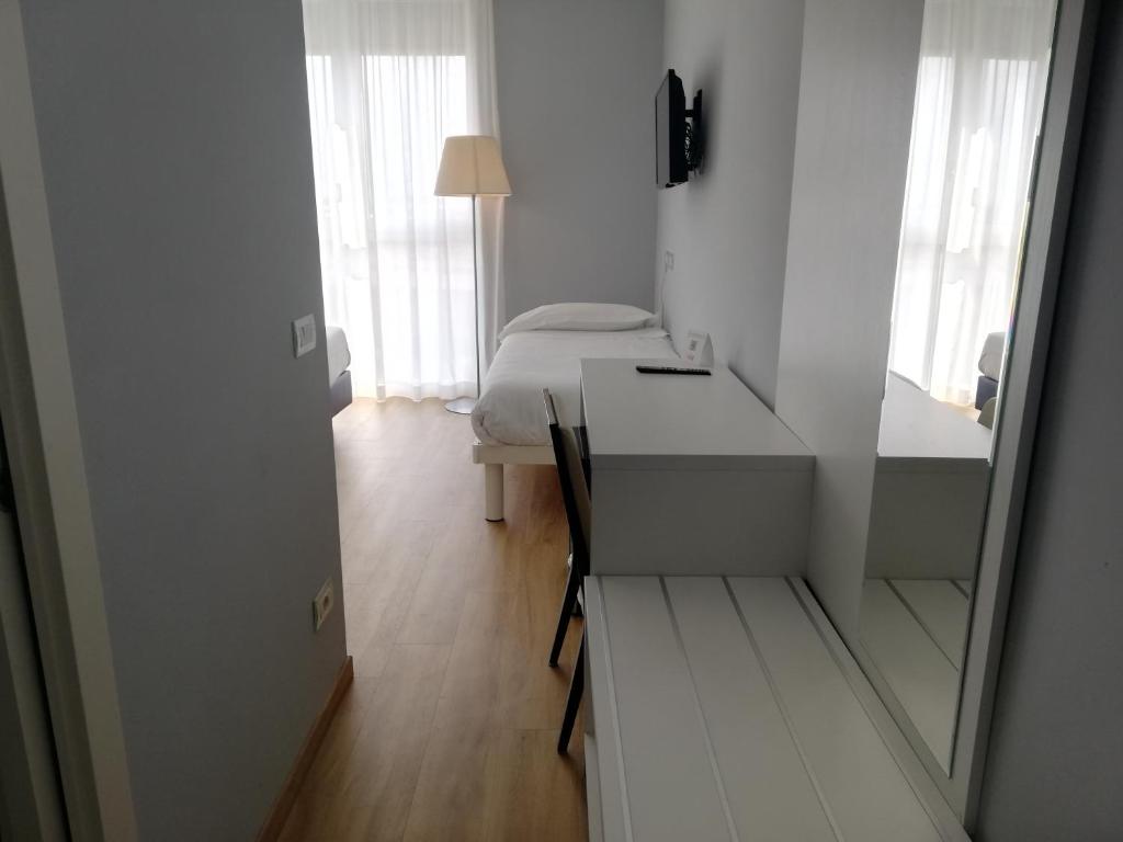 Łóżko lub łóżka w pokoju w obiekcie Novo Hotel Rossi