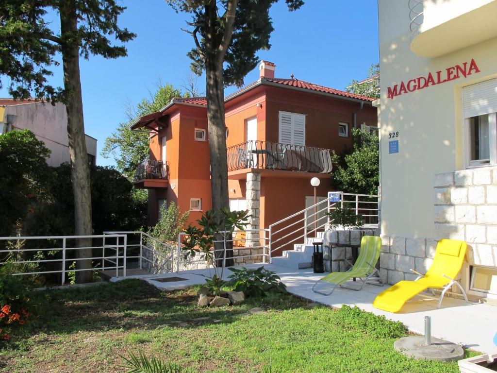 a house with a playground in front of it at Villas Arbia - Rio by the Beach in Rab