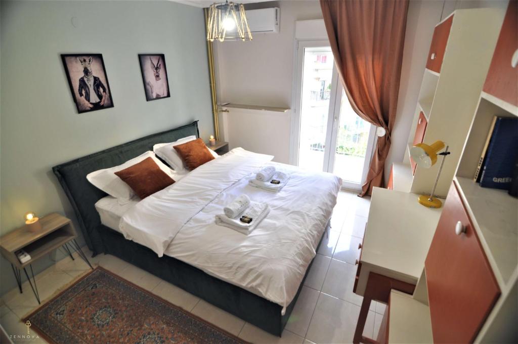 a bedroom with a bed with two dishes on it at Zennova #4 Vintage City Center Apt in Thessaloniki