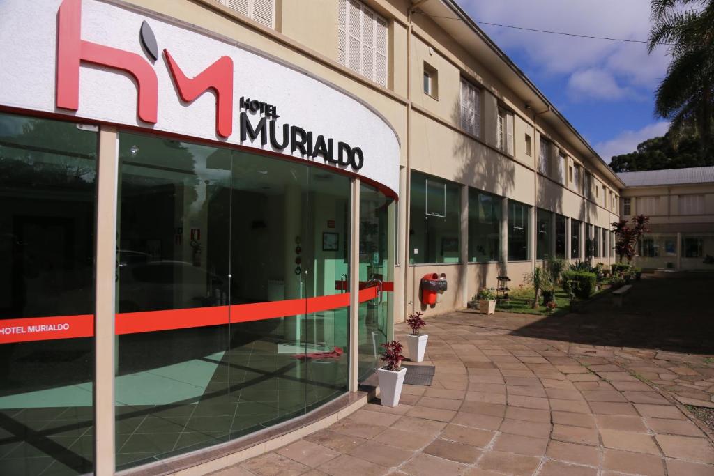 a large building with a sign on the side of it at Hotel Murialdo in Caxias do Sul
