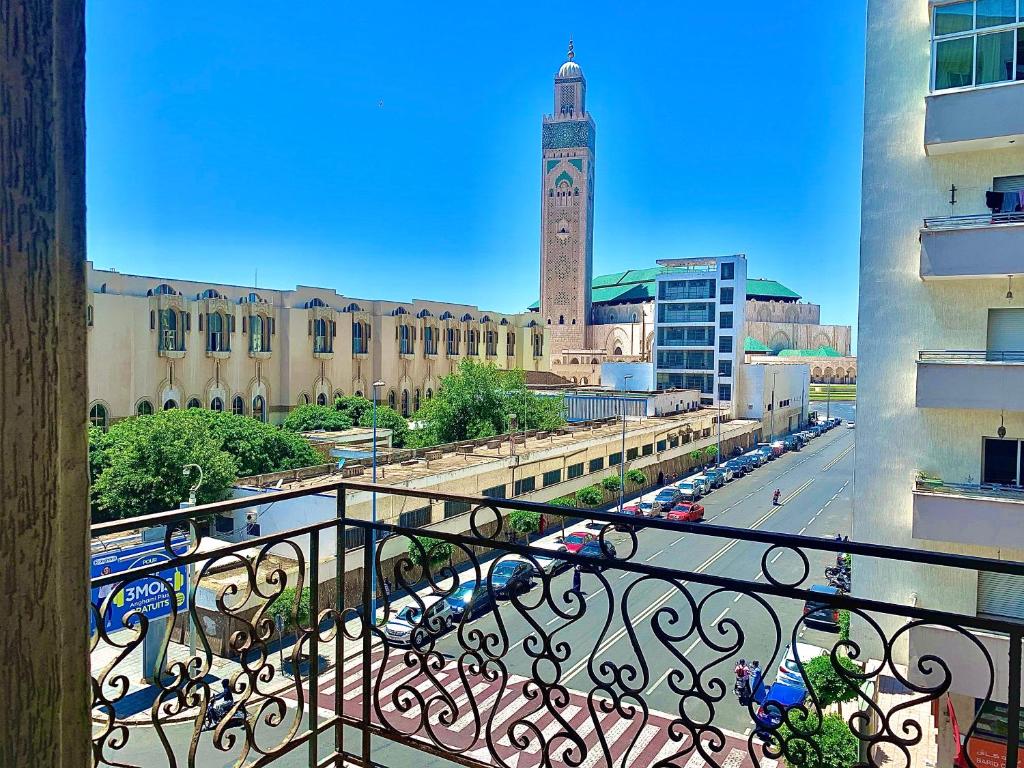 a balcony with a view of a clock tower at Sab 8 - Amazing view. 2 bedrooms in front of the mosque Hassan. Perfect location in Casablanca