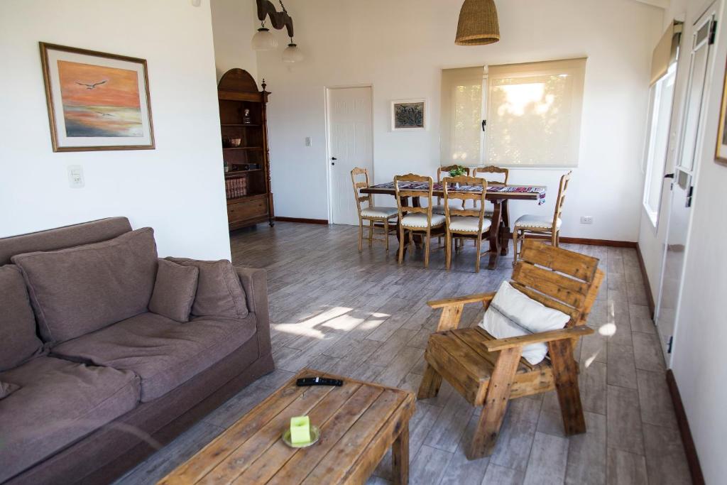 a living room with a couch and a table at Altos de Manantiales in El Calafate
