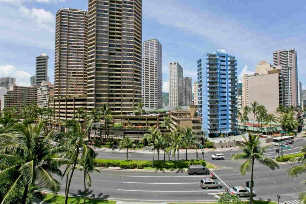 a city skyline with tall buildings and palm trees at Ilikai Tower 525 City View 2BR in Honolulu