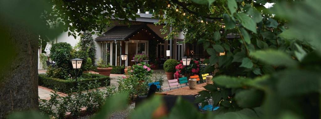 ein Haus mit einer Veranda mit Blumen und Pflanzen in der Unterkunft Landgasthof Läuterhäusle in Aalen