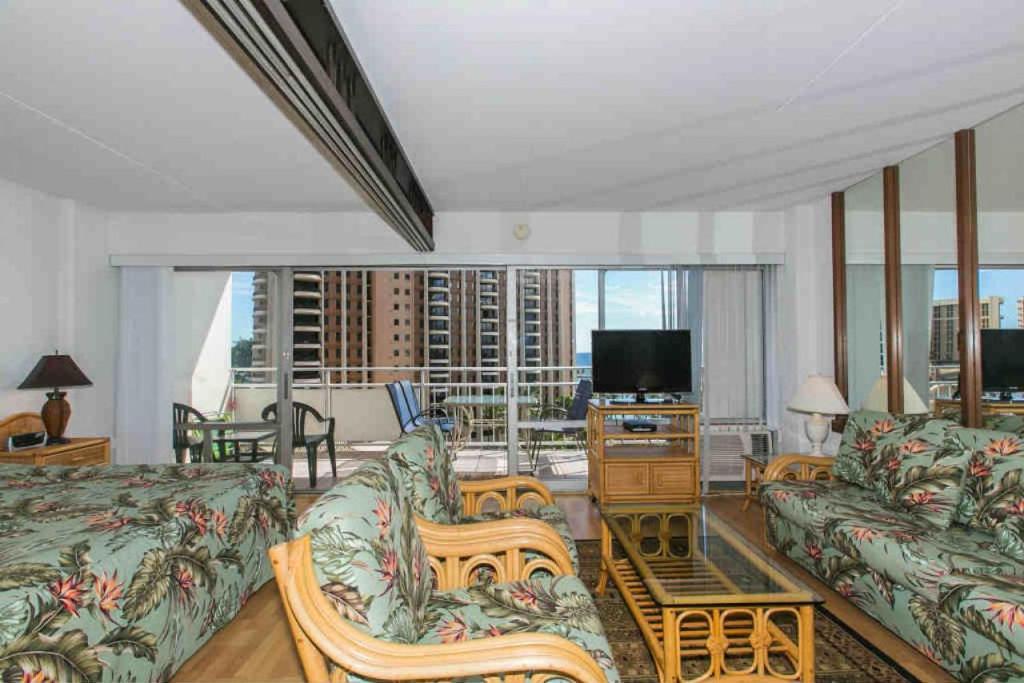 a living room with a couch and a television at Ilikai Tower 720 Lagoon View 1BR in Honolulu