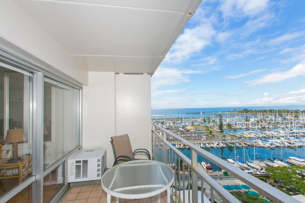 a balcony with a view of a marina at Ilikai Tower 1127 Yacht Harbor View 1BR in Honolulu