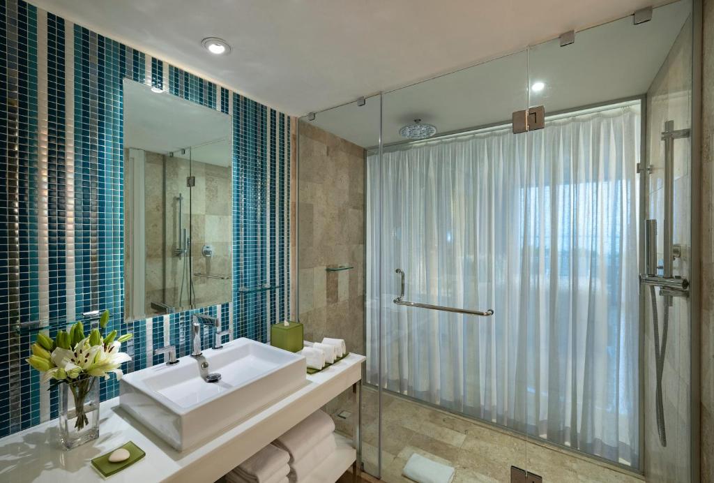 a bathroom with a sink and a shower at Paradisus Cancun All Inclusive in Cancún