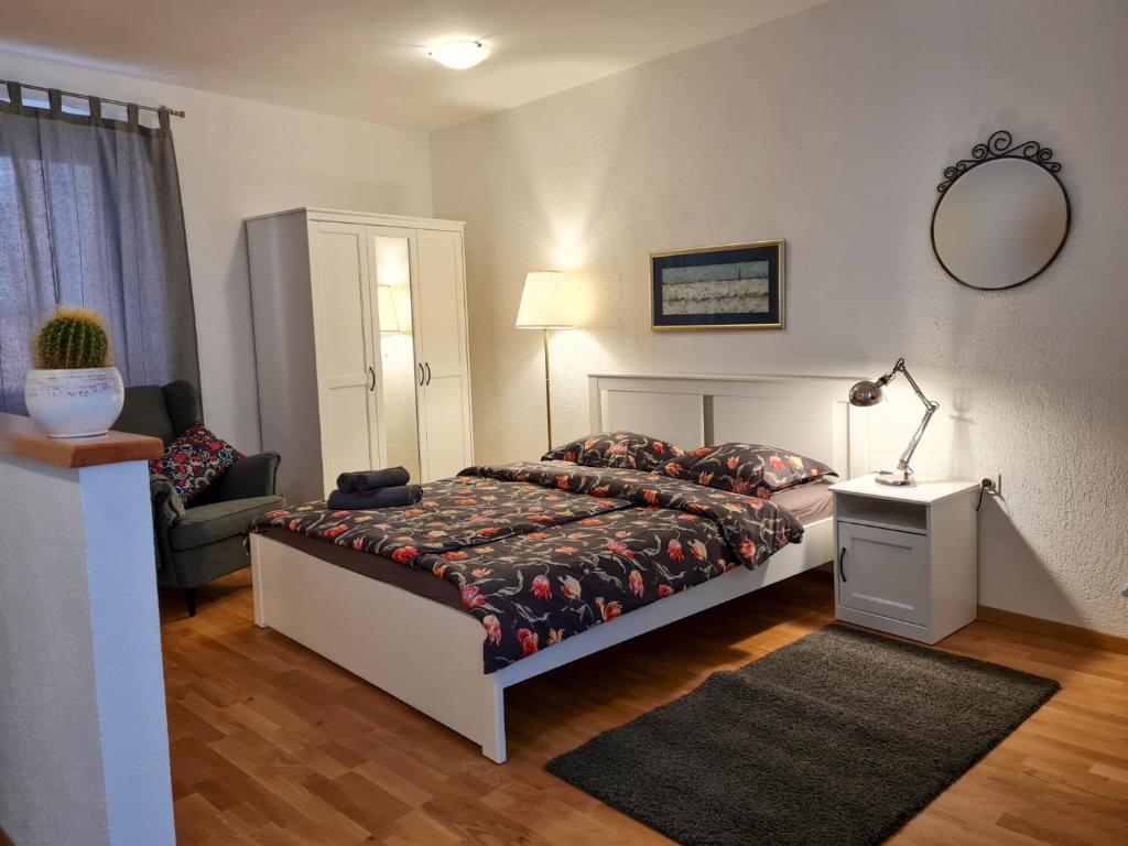a bedroom with a bed and a chair and a mirror at Old Town Apartments in Rovinj