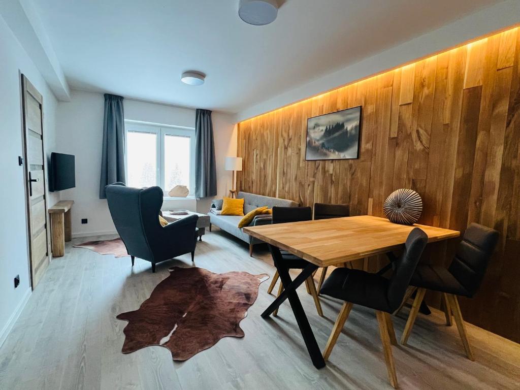 a dining room with a table and chairs at Apartmány Panorama Harrachov in Harrachov