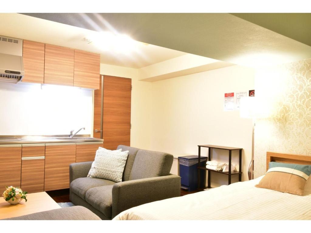 Giường trong phòng chung tại Alphabed Takamatsu Furujinmachi - Vacation STAY 11904