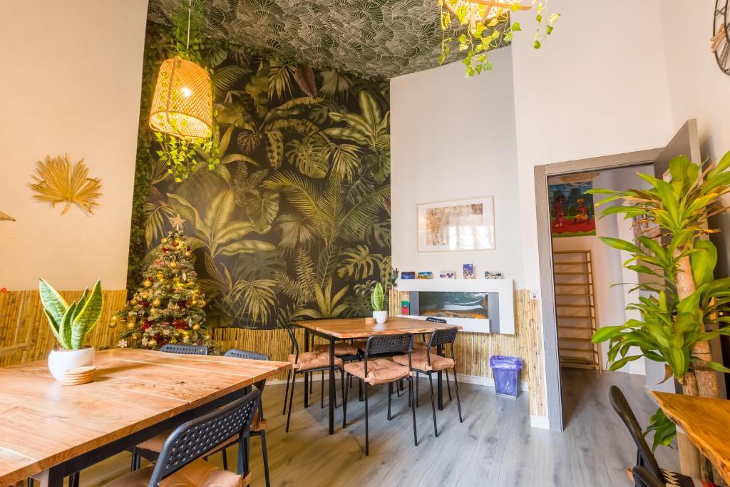 a dining room with tables and chairs and a christmas tree at Social - Coliving & Coworking - Madrid in Madrid