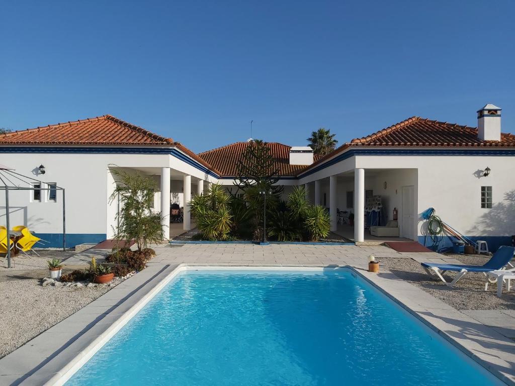 a swimming pool in front of a house at Casa Zanzibar Hotel in Landeira