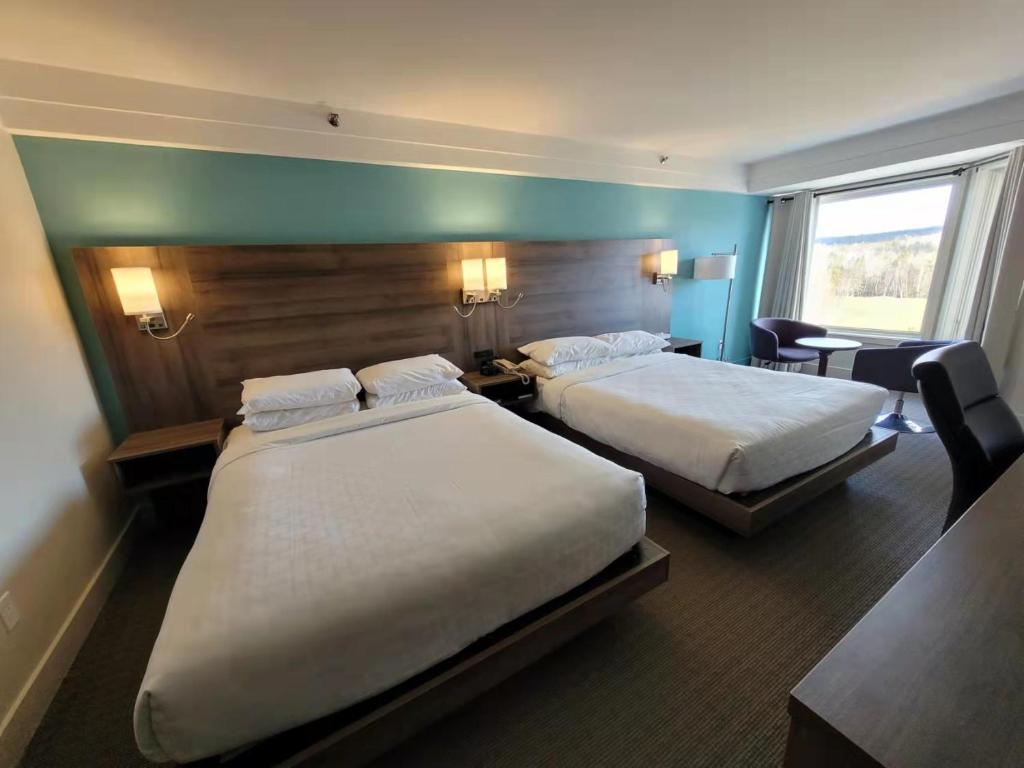 Postel nebo postele na pokoji v ubytování Manoir des Sables Hôtel & Golf