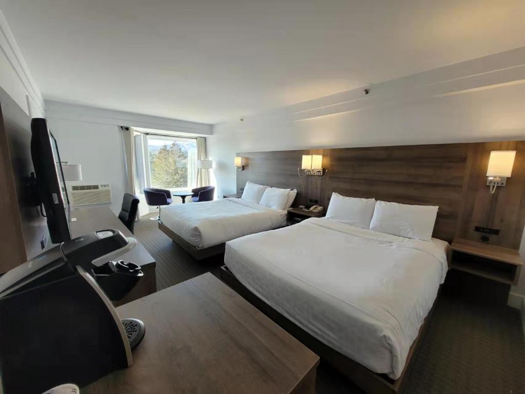 Postel nebo postele na pokoji v ubytování Manoir des Sables Hôtel & Golf