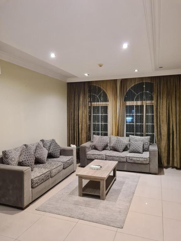 a living room with couches and a coffee table at روز نيري 2 in Al Khobar