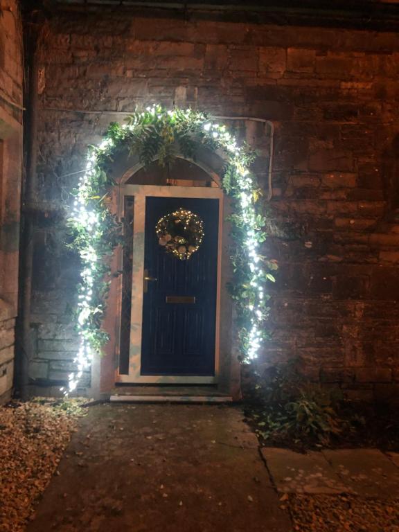 a door with a wreath and christmas lights at Stone Lodge B&B in Balrath