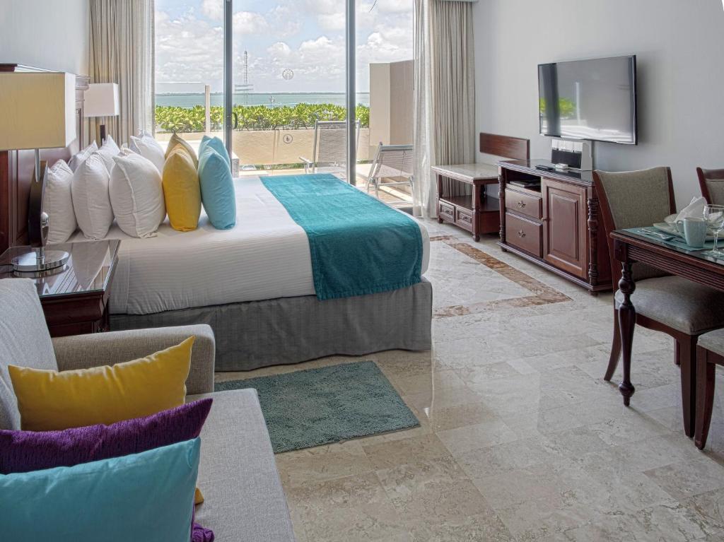 a hotel room with a bed and a television at Paradisus Cancun All Inclusive in Cancún