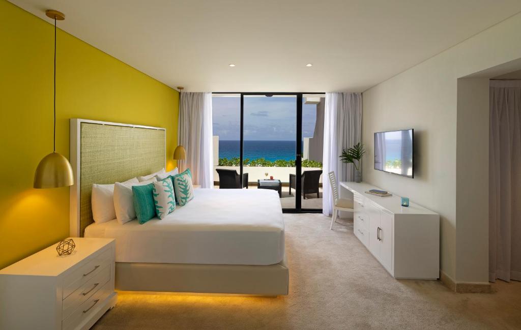 a bedroom with a bed and a view of the ocean at Paradisus Cancun All Inclusive in Cancún