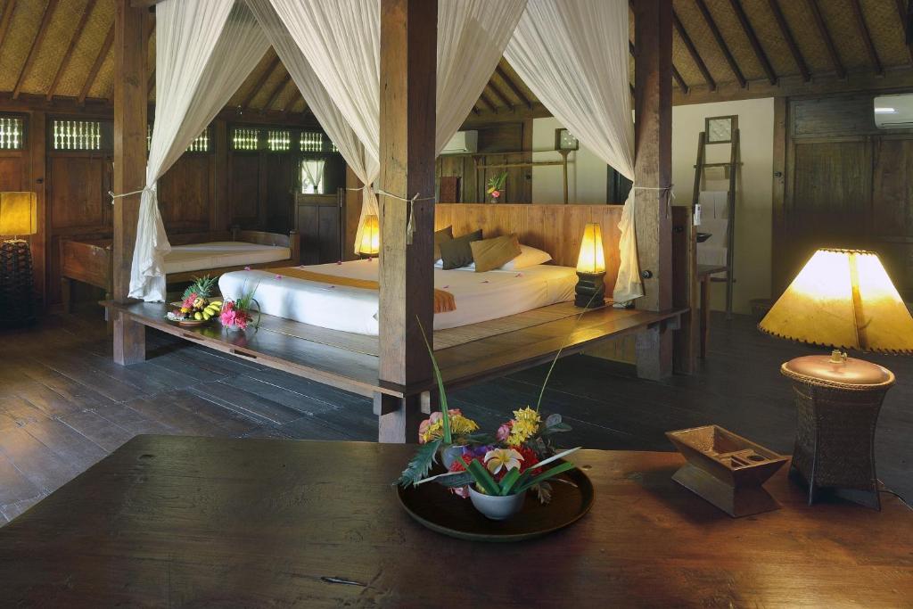 Postel nebo postele na pokoji v ubytování Desa Dunia Beda Resort