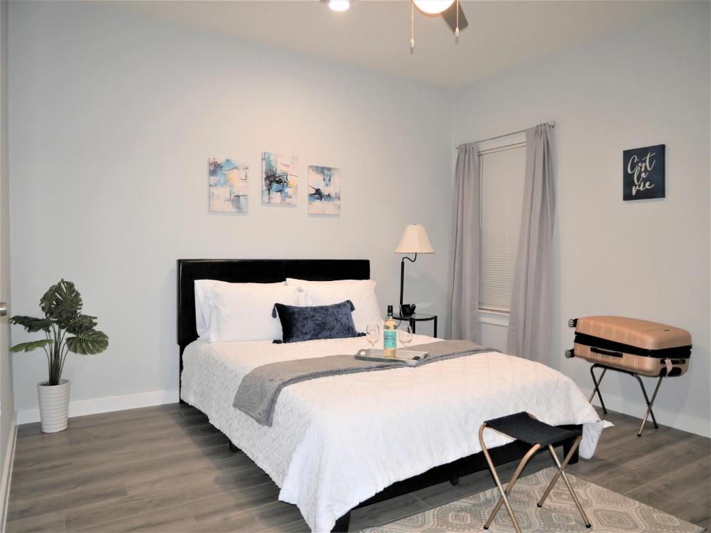 a bedroom with a large bed and a chair at Rare Vibrant Hidden Gem - 2 Mins from Downtown in Dallas