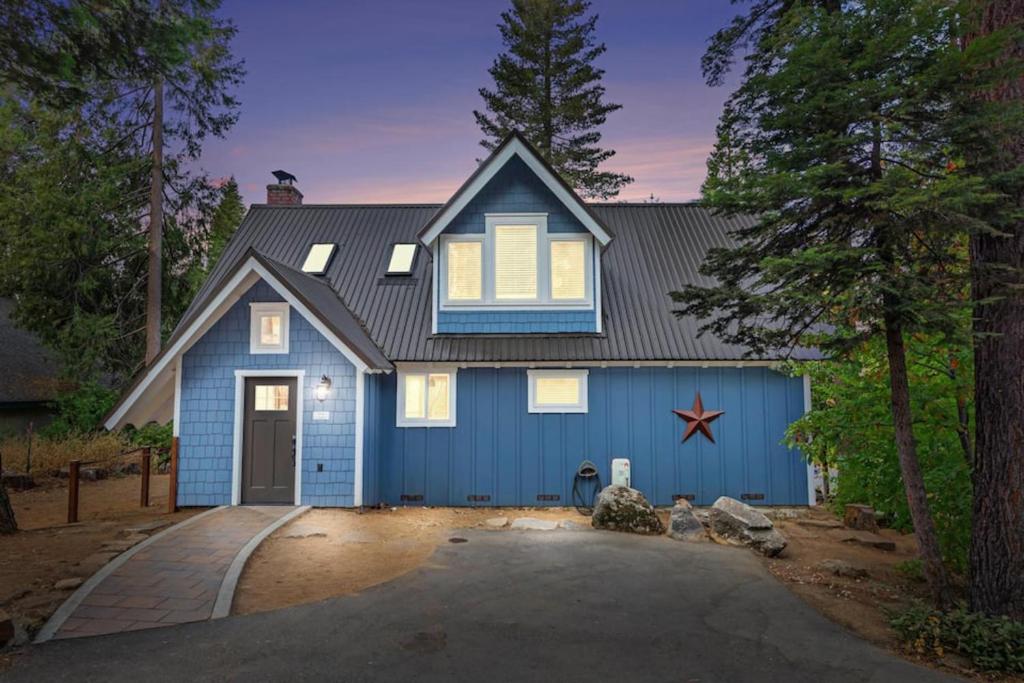 a blue house with a blue garage at Starfall in Yosemite West