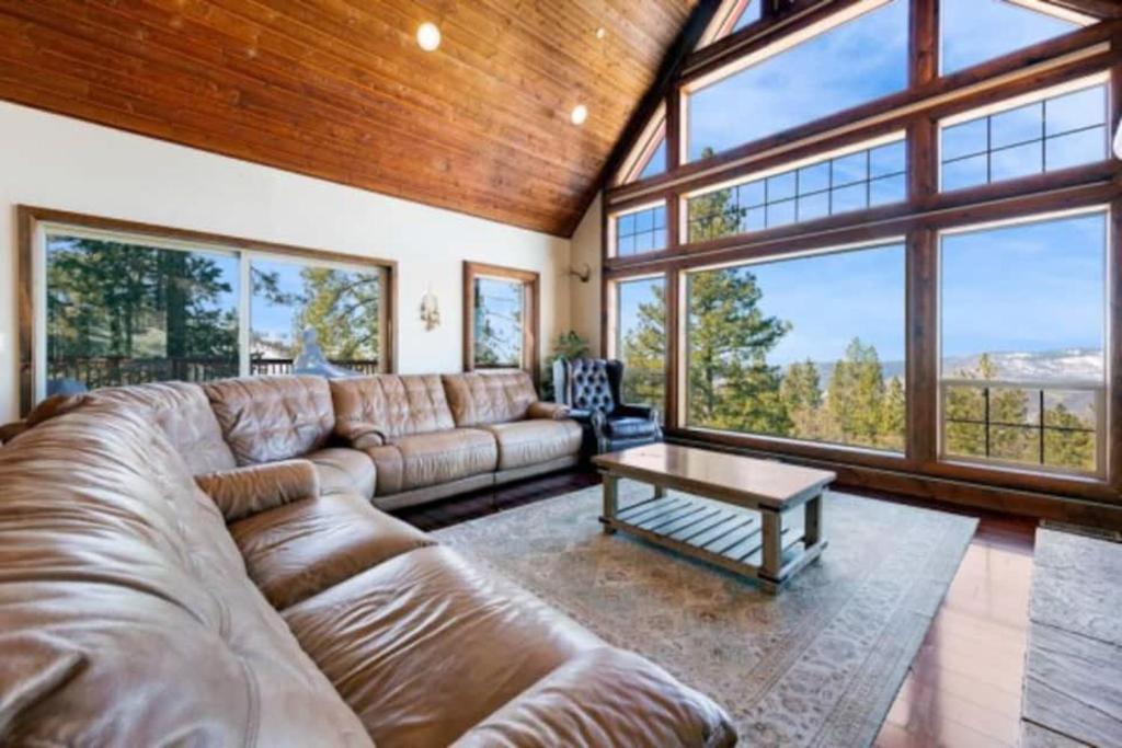 a large living room with a couch and a table at Glacier Peak Lodge in Yosemite West