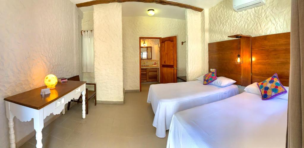 Posteľ alebo postele v izbe v ubytovaní Hotel Casa Lupita