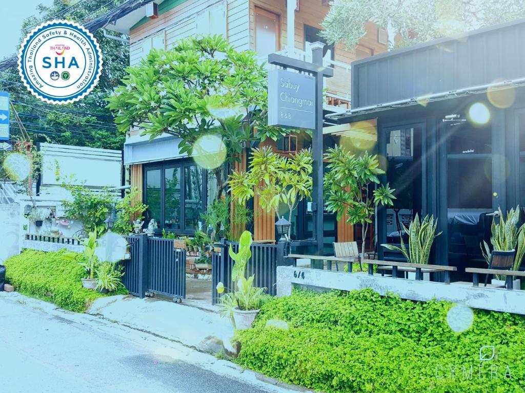 a store front with plants in front of it at Sabuy Chiangmai in Chiang Mai