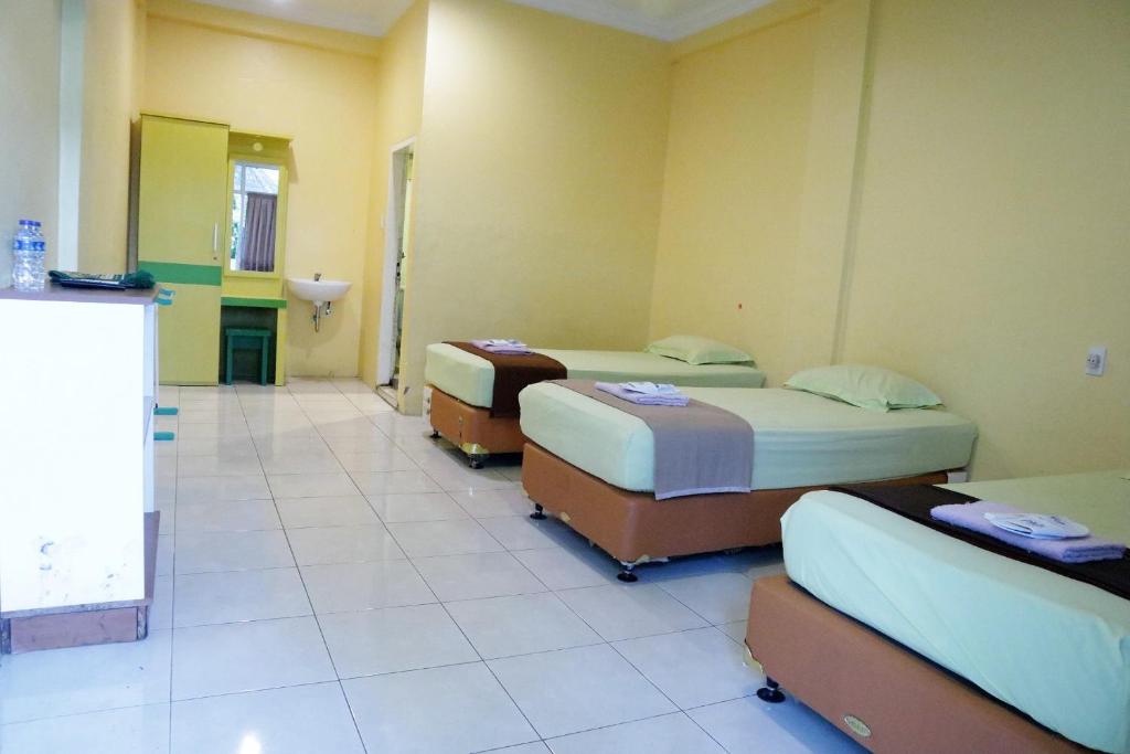 Postel nebo postele na pokoji v ubytování Plum Hotel Lading Banda Aceh