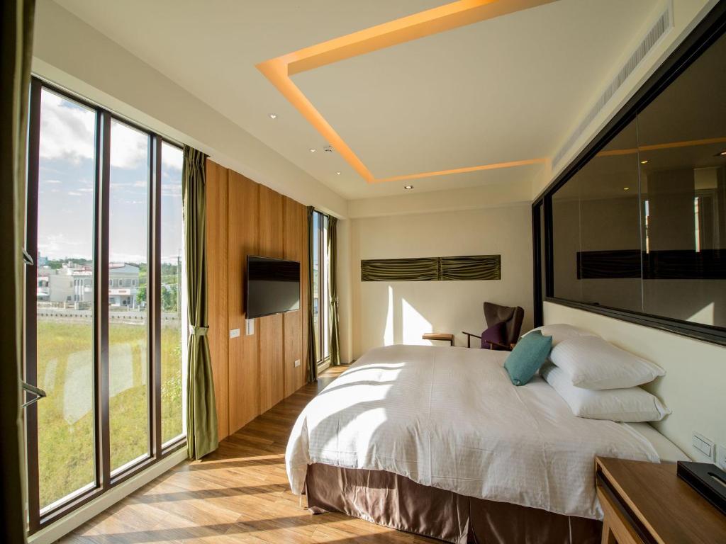 Postel nebo postele na pokoji v ubytování Beras Manor Kenting