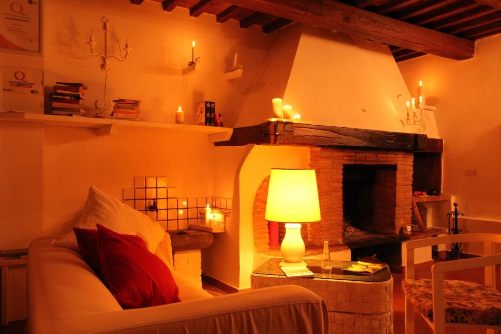 a living room with a couch and a fireplace at Gli Arancini in Quarrata