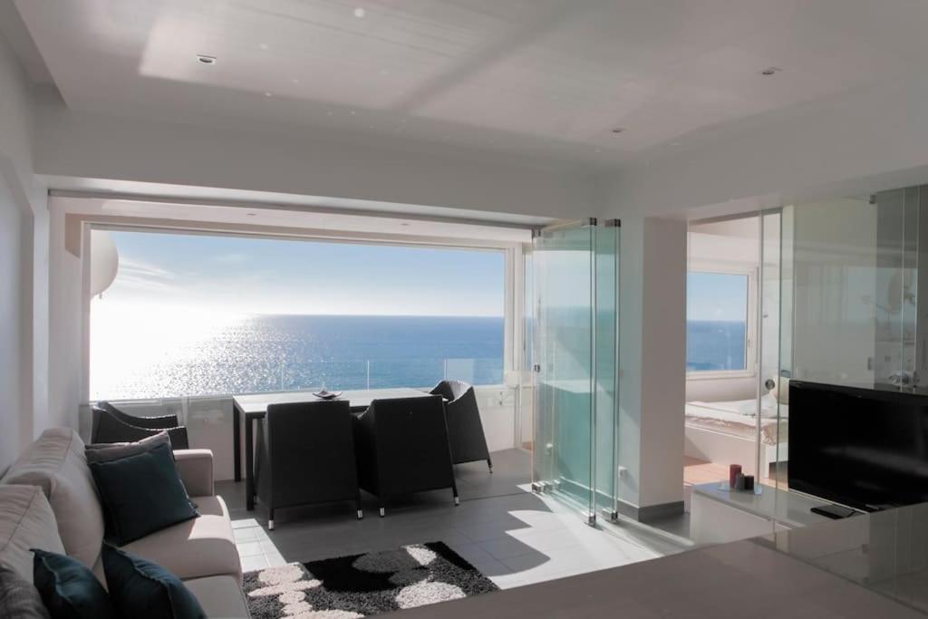 a living room with a view of the ocean at Atlantic Ocean View Suite Sesimbra in Sesimbra