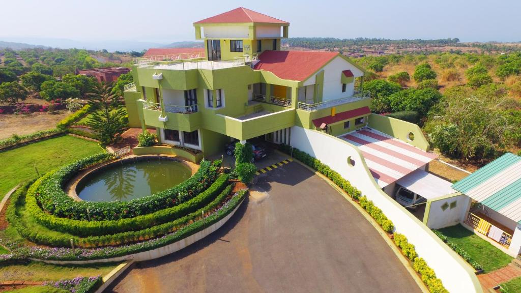 an aerial view of a house with a pool at Kokanwadi Resort in Ratnagiri
