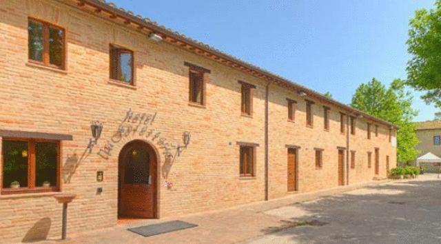 a brick building with graffiti on the side of it at Hotel La Foresteria in Abbadia di Fiastra