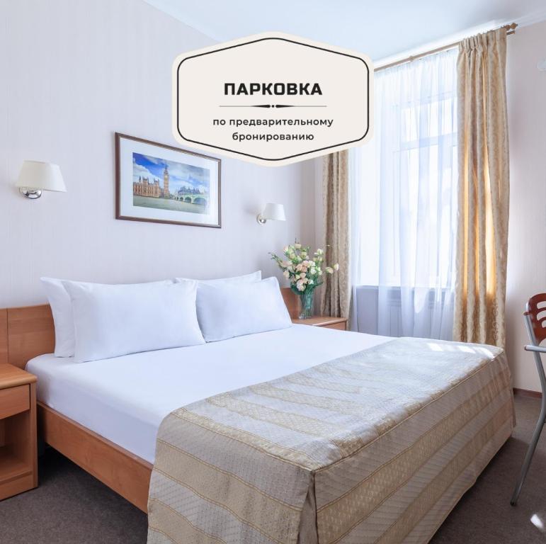 um quarto com uma grande cama branca num quarto em Tourist Hotel em São Petersburgo