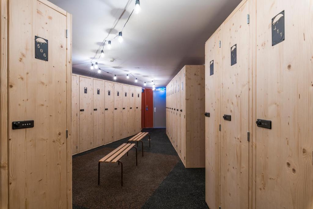 a row of benches in a locker room with wooden walls at Chalet Hotel Kaya in Les Menuires