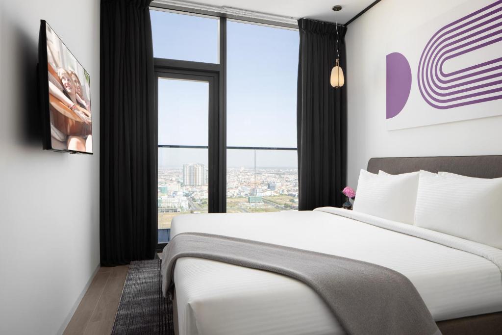 Postel nebo postele na pokoji v ubytování Citadines Flatiron Phnom Penh