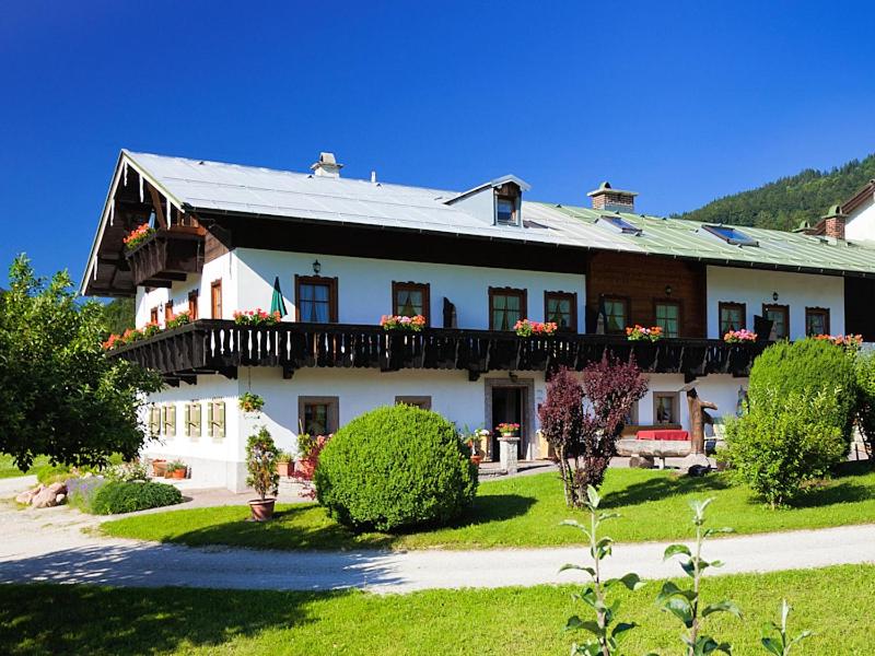 a large white house with a balcony on top of it at Ferienwohnungen Schwöblehen in Schönau am Königssee